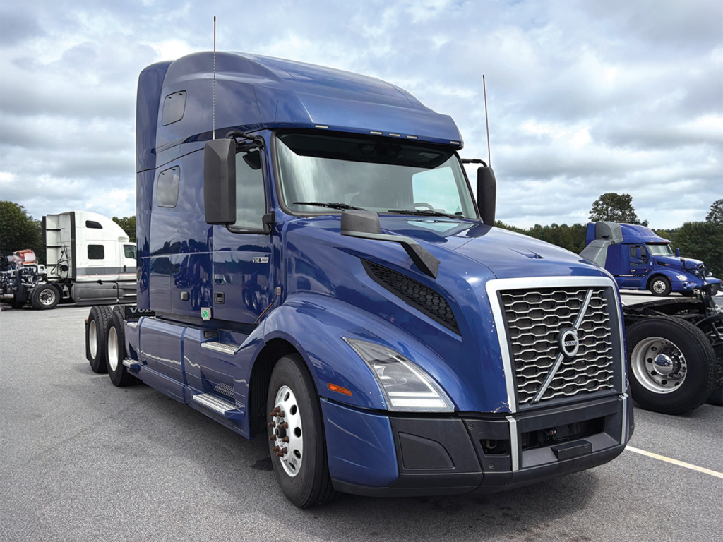 Volvo VNL 760 truck cab in blue, front view showing grille, headlights, and aerodynamic hood with badges.