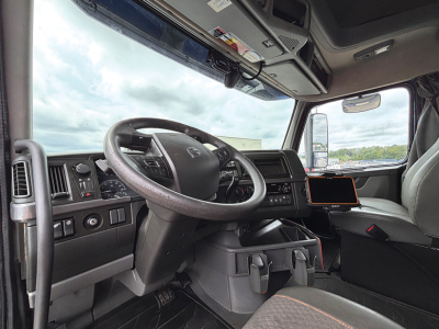 Volvo VNL 760 truck cab interior showing steering wheel, dashboard, and center console with mounted tablet.