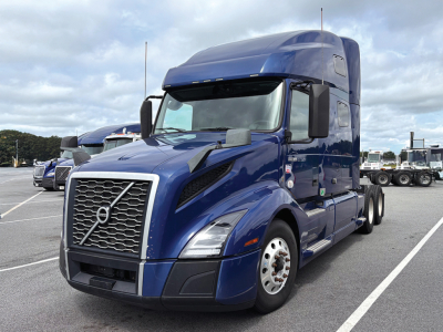 Volvo VNL 760 semi truck in blue, front-left view, grille with Volvo emblem, day cab style, with large side mirrors.