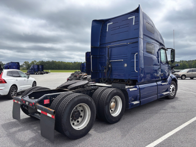 Volvo VNL 760 truck tractor rear and side view showing fifth-wheel and dual rear axles with blue cab and sleeper.