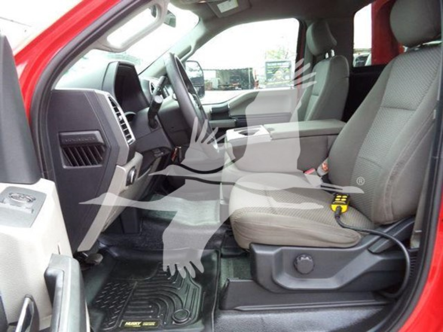 Ford F-450 interior front cabin view showing driver and passenger seats with black dash and steering wheel.