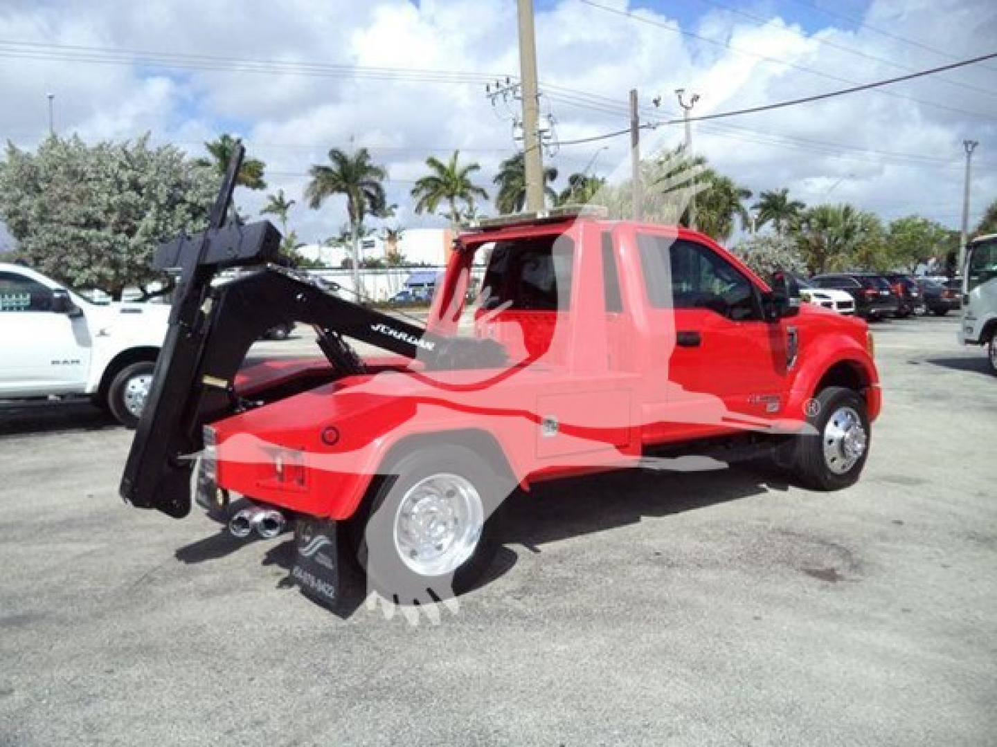 2017 Ford F450 tow truck with a mounted winch and crane in the bed. Visible text includes 'FORD' on the side and 'JERR-DYNE' on the winch crane arm.