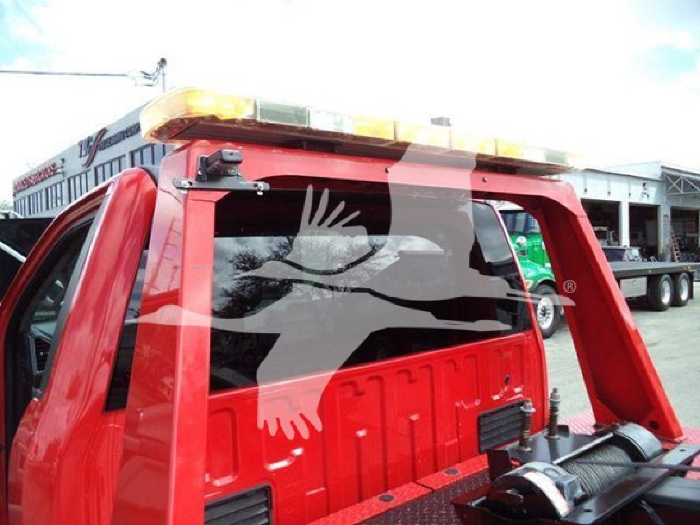 Truck bed with winch equipment on a red 2017 Ford F450, warning light bar on top, VIN 1FDUF4GT0HDA06355 visible in listing context.