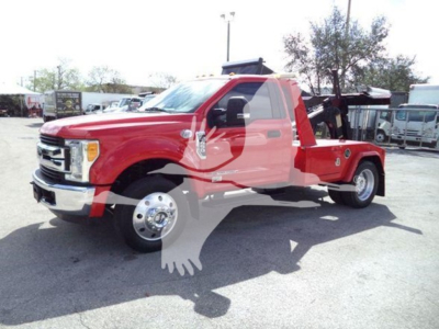 Ford F-450 tow truck in red with flatbed, side view showing the chassis and wheels.