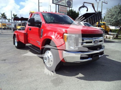 Ford F450 tow truck with winch attachment showing front grille and wheel