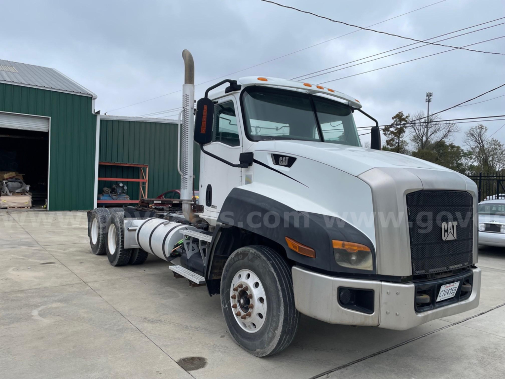 Truck cab and chassis showing CF7AA listing; Caterpillar badge on grille, exhaust stack, front bumper, drivetrain visible.