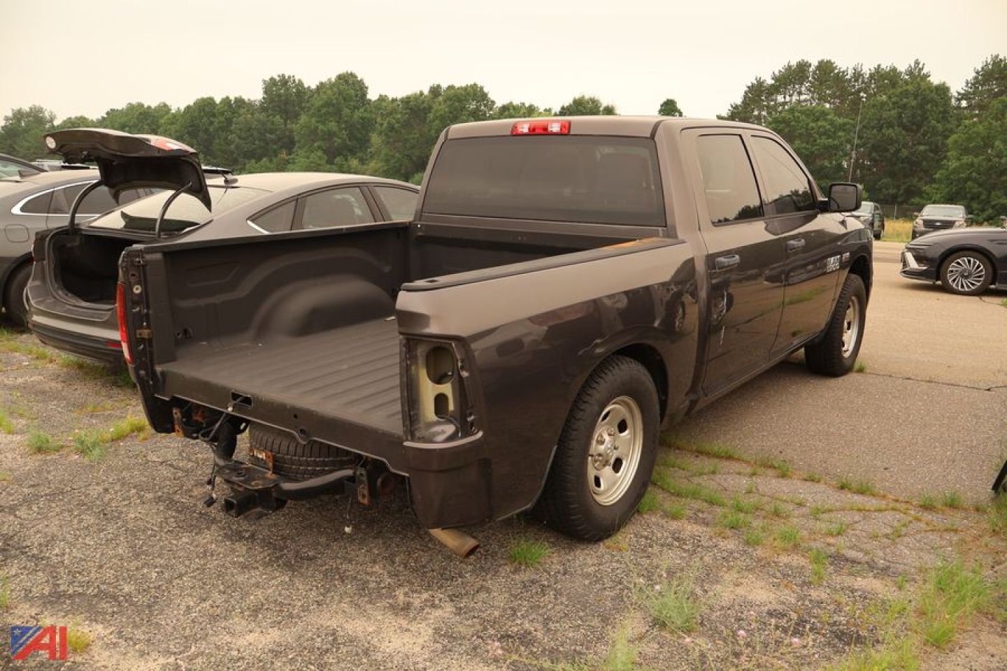 Ram 1500 pickup truck rear/side view with missing tailgate and exposed bed, 2015 model year