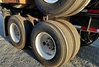 Trailer dual rear axles with white rims and black tires, visible undercarriage of a Gallegos 40' intermodal chassis.