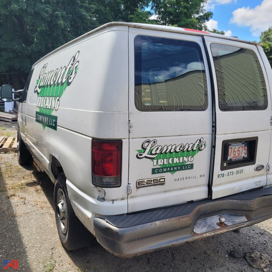 Ford E-Series van rear view with Lamont's Trucking branding and company logo on doors and back, model E250, MA license plate, white cargo van.