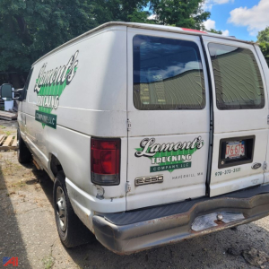 Ford E-Series van rear view with Lamont's Trucking branding and company logo on doors and back, model E250, MA license plate, white cargo van.