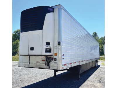 Utility reefer trailer showing Thermo King APX refrigeration unit at front left, white aluminum side panels, rear doors, and black support legs.