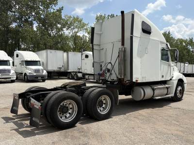 Truck chassis and cab of a used 2014 Freightliner CL120 Columbia with sleeper, showing rear axles and white exterior.