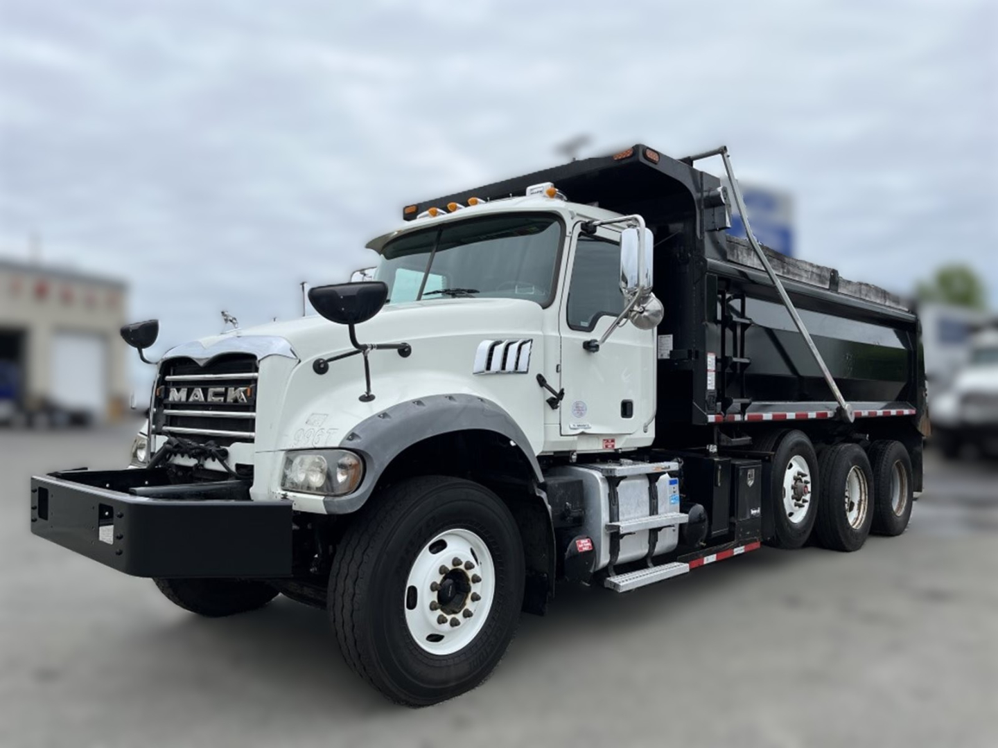 Mack GR84F dump truck in-service showing front bumper with winch and