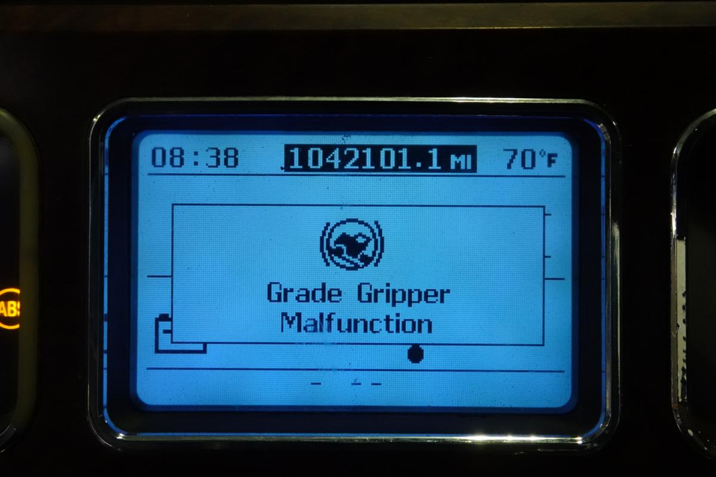 Mack truck instrument display showing Grade Gripper Malfunction warning with mileage 1042101.1 mi and 70°F, time 08:38.