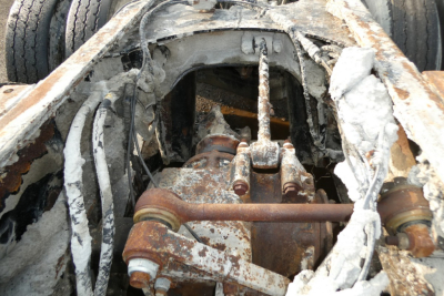 Mack mixer truck chassis interior showing corroded hydraulic pump and frame components.