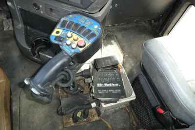 Mack CTP713 mixer cab interior showing control console with blue panel and McNeilus power unit wiring.