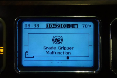 Mack truck instrument display showing Grade Gripper Malfunction warning with mileage 1042101.1 mi and 70°F, time 08:38.