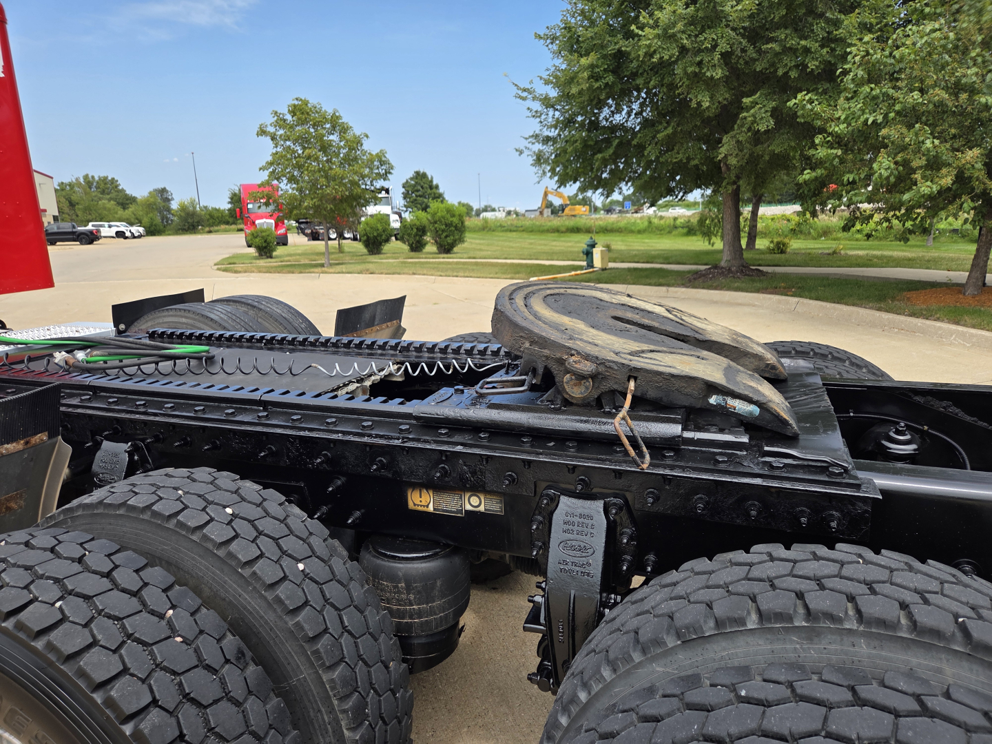 Peterbilt truck chassis showing rear section with fifth wheel and dual rear axles.