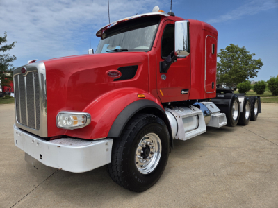 Peterbilt 567 truck cab with red body, chrome grille, and white bumper. Visible text includes Peterbilt emblem on the side of the hood and a badge. The image shows a VIN and stock number in the listing: 1XPCP4EX8LD688055 and 0628025.