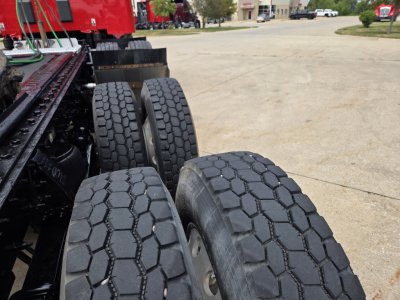 Peterbilt truck rear dual axle wheels with heavy tread tires, part of a conventional sleeper truck chassis.