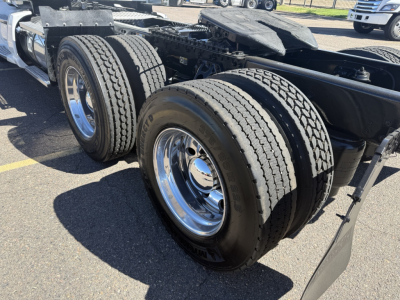 Kenworth T680 tractor rear dual wheels and chassis showing tires and chrome wheels.