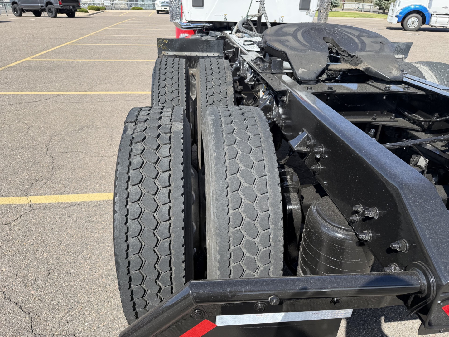 Kenworth T880 chassis and dual rear axles showing twin tires and frame rails.