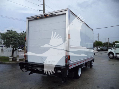 Box truck rear view showing Isuzu NPR-HD style box with plain white doors and black undercarriage, no legible text visible on the vehicle itself.