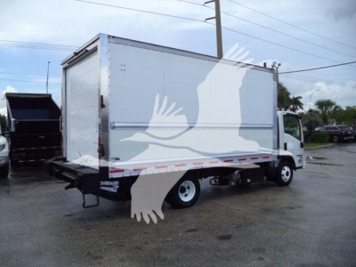 Isuzu NPR-HD box truck rear and side view showing large white cargo box on chassis with dual rear wheels and reflective tape.