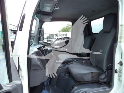 Isuzu NPR HD truck cabin interior showing driver seat and dashboard from open door