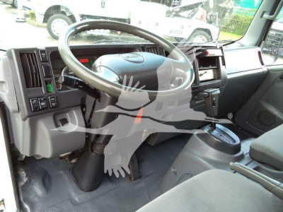 Isuzu NPR HD truck interior showing steering wheel and dashboard with center console and gear lever.