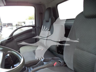 Isuzu NPR-HD truck interior showing driver and passenger seats with steering wheel and dashboard visible