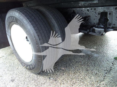 Isuzu NPR HD truck rear dual wheels showing tire and undercarriage components.