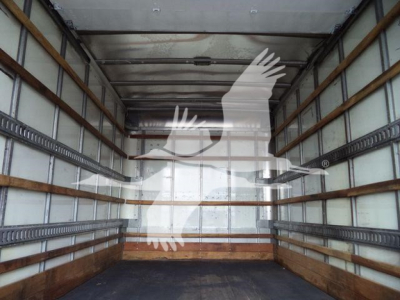 Truck trailer interior showing empty load area with metal side rails, wooden floor strips, and overhead ribs.