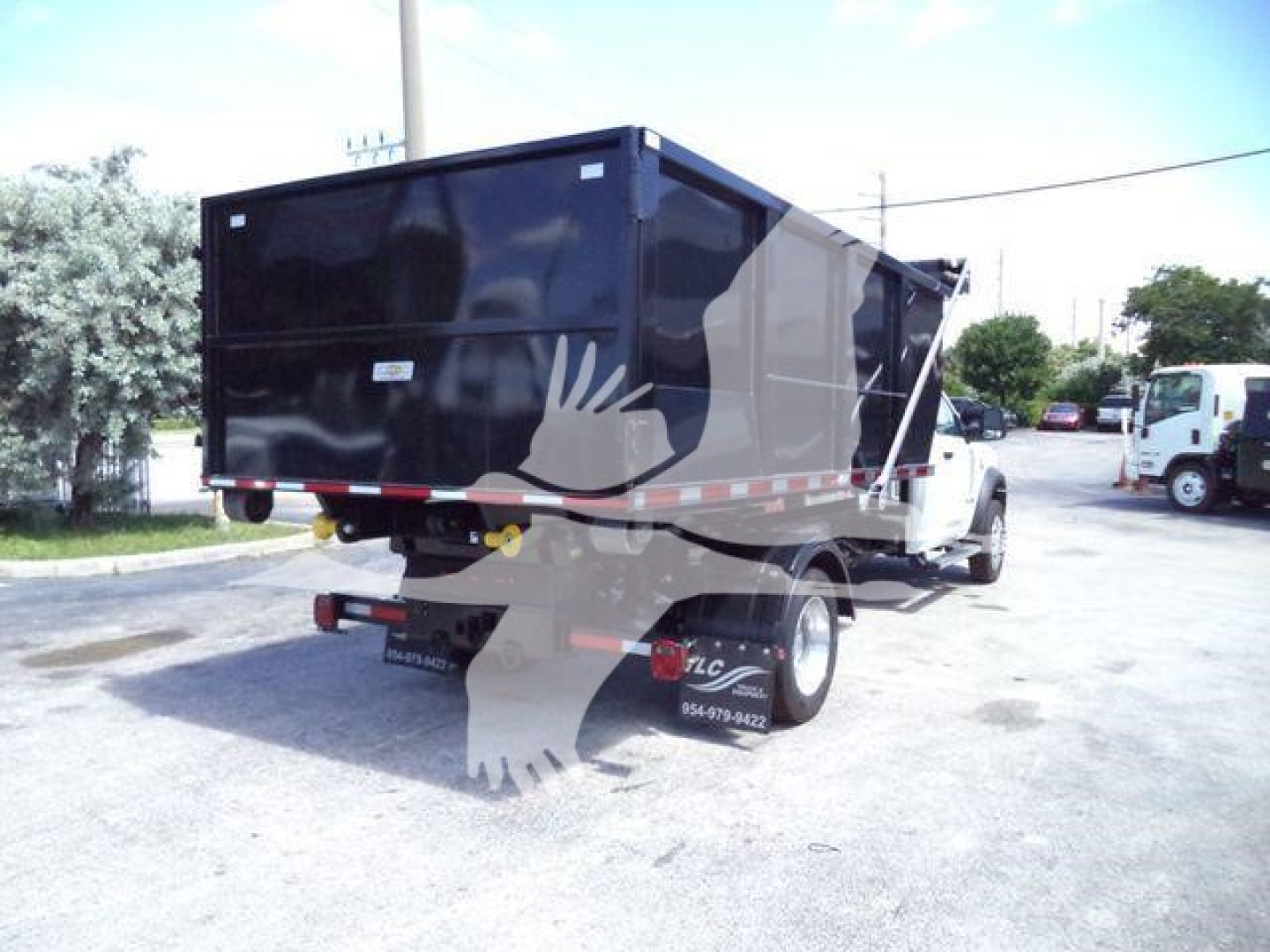 Ram 5500 dump bed truck rear view showing solid black dump body and rear lights.