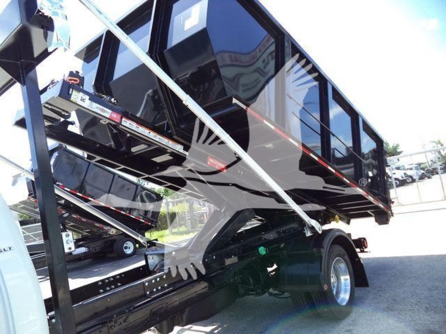 Ram 5500 HD SLT dump bed side view showing rolloff truck body and hydraulic hoist components.