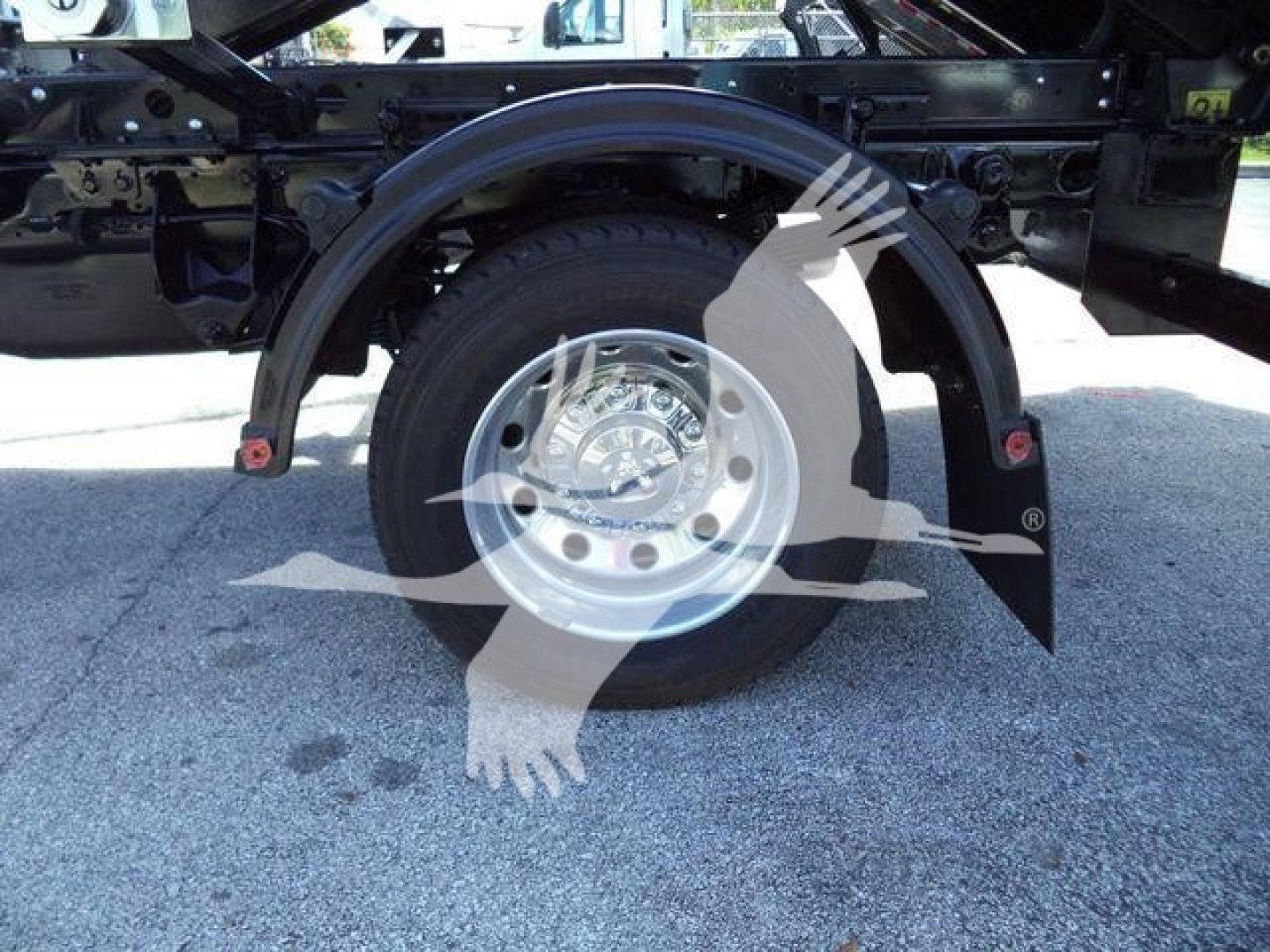 Wheel well and hub of a 2024 Ram 5500 HD SLT chassis with silver alloy wheel, black frame, and fender liners visible.