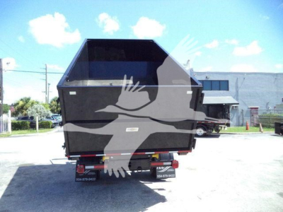 Ram 5500 HD SLT dump truck rear view showing black dump body and hitch with license plate area.