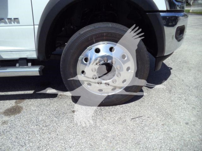 Ram 5500 cab-forward front wheel well and tire close-up showing chrome hubcap and wheel assembly.