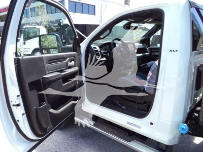 Ram 5500 HD SLT cab interior and open driver door showing dashboard and seating with side step, white exterior.