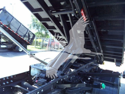 Ram 5500 HD SLT truck equipment bay with hydraulic components and frame. Visible text includes red warning tag and markings on metal structure.