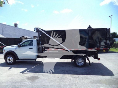 Ram 5500 HD SLT dump truck side view with black dump body and white cab, stock number DSL550014SNG4X4.