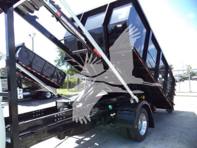 Ram 5500 HD SLT truck in-service with raised dump bed and hydraulic mechanism showing tilt and cabin area.