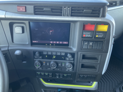 Volvo VNL dash cluster showing touchscreen display and control panels with warning lights and climate controls.