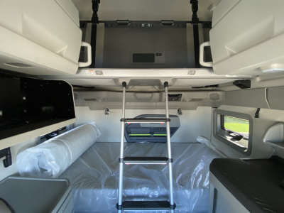 Volvo VNL64T860 truck cabin interior with bunk beds, ladder, and storage compartments visible.
