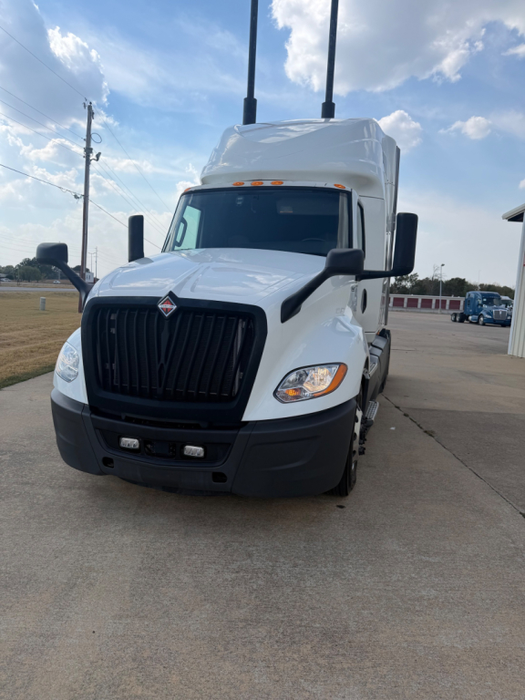 International LT Series truck front/view showing cab and grille with black bumper and dual vertical exhaust stacks.