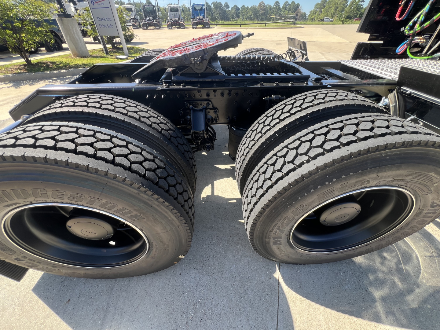 Dual rear trailer tires on a Volvo VNL64T840 tractor chassis view showing tire treads and hub caps.