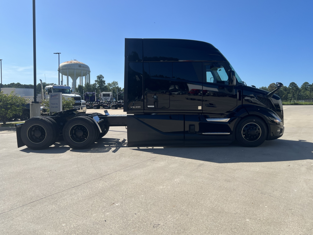 Volvo VNL64T840 truck tractor side view showing sleeper cab and 6x4 rear axle configuration.