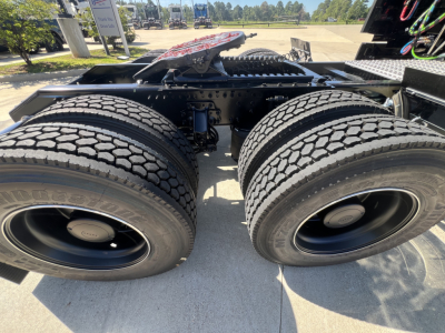 Dual rear trailer tires on a Volvo VNL64T840 tractor chassis view showing tire treads and hub caps.