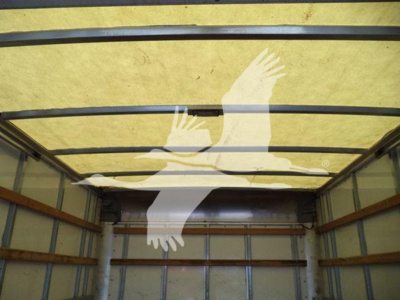 Isuzu NPR HD truck cargo area interior with overhead insulation and crossbars.