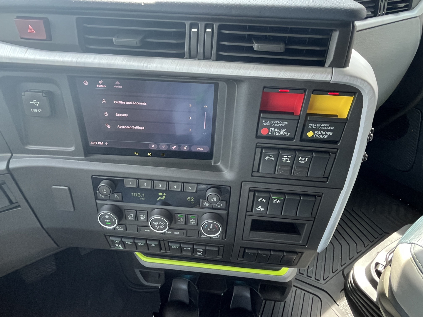 Volvo VNL64T840 dashboard and center console showing touchscreen infotainment and climate controls.